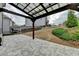 Backyard view showcasing the hardscaped patio, landscaping, and dark metal fence at 6585 Creekview Cir, Duluth, GA 30097