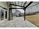 Backyard view showcasing the hardscaped patio, landscaping, and dark metal fence at 6585 Creekview Cir, Duluth, GA 30097
