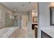 Bathroom with tub, shower with glass door, quartz countertop and walk-in closet at 6585 Creekview Cir, Duluth, GA 30097