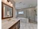 This bathroom features a double sink vanity with a large tub and walk-in shower at 6585 Creekview Cir, Duluth, GA 30097