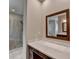 This bathroom features a vanity with quartz countertop and a mirror with wood frame at 6585 Creekview Cir, Duluth, GA 30097