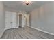 Neutral bedroom with a bay window and light gray wood flooring plus a large closet and bright lighting at 6585 Creekview Cir, Duluth, GA 30097