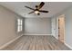 Bedroom features hardwood floors, ceiling fan, and one window with plantation shutters at 6585 Creekview Cir, Duluth, GA 30097