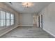 Large bedroom with gray wood flooring, shuttered window, and multiple doors at 6585 Creekview Cir, Duluth, GA 30097