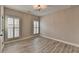 This bedroom has two windows and laminate flooring at 6585 Creekview Cir, Duluth, GA 30097