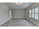 Spacious bedroom with gray wood flooring, neutral walls, and shuttered windows at 6585 Creekview Cir, Duluth, GA 30097