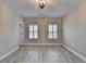 Spacious bedroom with wood flooring, neutral walls, chandelier, and shuttered windows at 6585 Creekview Cir, Duluth, GA 30097