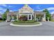 Community entrance featuring stone gatehouse with detailed landscaping and access control at 6585 Creekview Cir, Duluth, GA 30097
