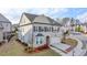 Aerial view of a charming two-story home featuring a two-car garage, a landscaped yard, and a mix of brick and siding exterior at 6585 Creekview Cir, Duluth, GA 30097
