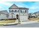 Charming two-story home featuring a two-car garage, a landscaped yard, and a mix of brick and siding exterior at 6585 Creekview Cir, Duluth, GA 30097