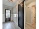 Modern entryway with stylish barn door, paneled walls, and hardwood flooring at 6585 Creekview Cir, Duluth, GA 30097