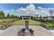 Beautiful green space with fountain and pergola, surrounded by manicured landscaping and stone pathways at 6585 Creekview Cir, Duluth, GA 30097