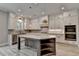 Bright kitchen with granite counters, white cabinetry, stainless appliances, central island, and pendant lighting at 6585 Creekview Cir, Duluth, GA 30097