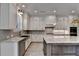 Stylish kitchen with white cabinets, granite countertops, stainless steel appliances, and large island at 6585 Creekview Cir, Duluth, GA 30097