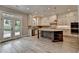 Bright, spacious kitchen with island, stainless appliances, and light wood flooring with access to outdoor patio at 6585 Creekview Cir, Duluth, GA 30097