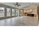 Open-concept living room with seamless access to a modern kitchen, featuring ample windows for natural light at 6585 Creekview Cir, Duluth, GA 30097