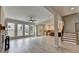 Sunlit living room featuring large windows, wood-look floors, and an open view of the modern kitchen at 6585 Creekview Cir, Duluth, GA 30097