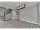 Minimalist living room featuring wood-look floors and modern light fixture, creating a bright and welcoming atmosphere at 6585 Creekview Cir, Duluth, GA 30097