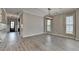 Spacious living and dining area with hardwood floors, modern lighting, and views of the entryway at 6585 Creekview Cir, Duluth, GA 30097