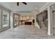 Bright living room featuring an open layout, offering access to the kitchen and backyard through French doors at 6585 Creekview Cir, Duluth, GA 30097