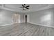 Spacious main bedroom featuring tray ceilings, wood floors, and lots of natural light at 6585 Creekview Cir, Duluth, GA 30097