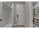Mud room with built-in storage, shelving, and hooks for organization, and a door to the outside at 6585 Creekview Cir, Duluth, GA 30097