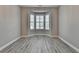Versatile room with large bay windows providing ample natural light and modern gray flooring at 6585 Creekview Cir, Duluth, GA 30097