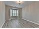 Versatile room with large bay windows providing ample natural light and modern gray flooring at 6585 Creekview Cir, Duluth, GA 30097