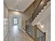 Beautiful staircase with modern railing and views to the entry of a living area at 6585 Creekview Cir, Duluth, GA 30097