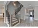 Elegant staircase featuring wood steps and iron railing with wainscoting, creating a stylish focal point at 6585 Creekview Cir, Duluth, GA 30097
