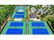 Aerial view of tennis courts surrounded by well-maintained green space and trees at 6585 Creekview Cir, Duluth, GA 30097