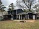 Rear view of the home with an outdoor patio area, screened-in porch, and a spacious backyard at 6921 Babbling Brook Dr, Rex, GA 30273