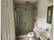 A stylish bathroom featuring tiled shower with glass door, vanity, and modern fixtures at 6921 Babbling Brook Dr, Rex, GA 30273