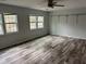 Spacious bedroom with modern floors and two windows providing lots of natural light at 6921 Babbling Brook Dr, Rex, GA 30273