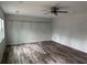 Large bedroom with a ceiling fan, shelving, and natural light; ready for customization at 6921 Babbling Brook Dr, Rex, GA 30273