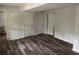 Finished bedroom with light-colored walls, wood-look floors, and access to storage or closet space at 6921 Babbling Brook Dr, Rex, GA 30273