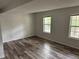 Spacious bedroom featuring modern flooring and ample natural light from two large windows at 6921 Babbling Brook Dr, Rex, GA 30273