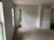 A spacious bedroom with neutral walls, carpet floors and two windows at 6921 Babbling Brook Dr, Rex, GA 30273