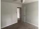 An airy bedroom featuring neutral decor and natural light with access to a bathroom at 6921 Babbling Brook Dr, Rex, GA 30273
