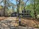 Charming two-story home with a dark gray exterior, white trim, and a welcoming front porch at 6921 Babbling Brook Dr, Rex, GA 30273