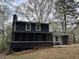 A charming house with a screened porch, offering a cozy outdoor living space and a peaceful view of the surroundings at 6921 Babbling Brook Dr, Rex, GA 30273