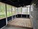 A spacious screened porch offering a relaxing outdoor living space with wooded views at 6921 Babbling Brook Dr, Rex, GA 30273