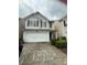 Two-story home featuring a front-facing garage and neutral siding with gray shutters at , Covington, GA 30016