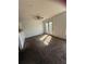 A living room with carpeted floors, natural light, and access to the outside through French doors at , Covington, GA 30016