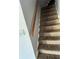 Carpeted staircase with a wooden handrail leading to the upper level at , Covington, GA 30016
