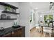 Stylish bar area with floating shelves and a view of the dining room and living room at 1604 Niskey Lake Sw Rd, Atlanta, GA 30331