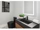Modern powder room featuring a floating vanity with black sink, toilet, and minimalist artwork at 1604 Niskey Lake Sw Rd, Atlanta, GA 30331