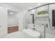 Bright bathroom featuring a freestanding tub and frameless glass shower with white marble at 1604 Niskey Lake Sw Rd, Atlanta, GA 30331