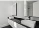 Bright and modern bathroom featuring dual sinks and a frameless shower with black accents at 1604 Niskey Lake Sw Rd, Atlanta, GA 30331