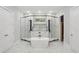 Luxurious bathroom featuring a freestanding tub and glass-enclosed shower with marble tile at 1604 Niskey Lake Sw Rd, Atlanta, GA 30331